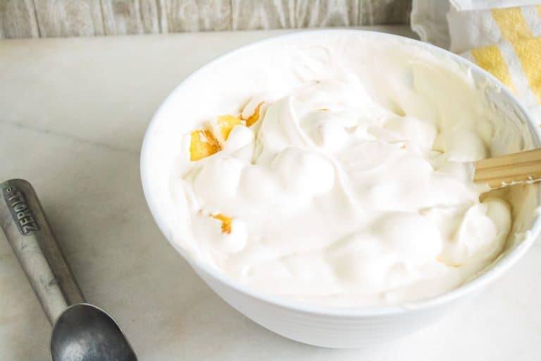 tropical no-churn ice cream mixed up in a bowl ready to be frozen