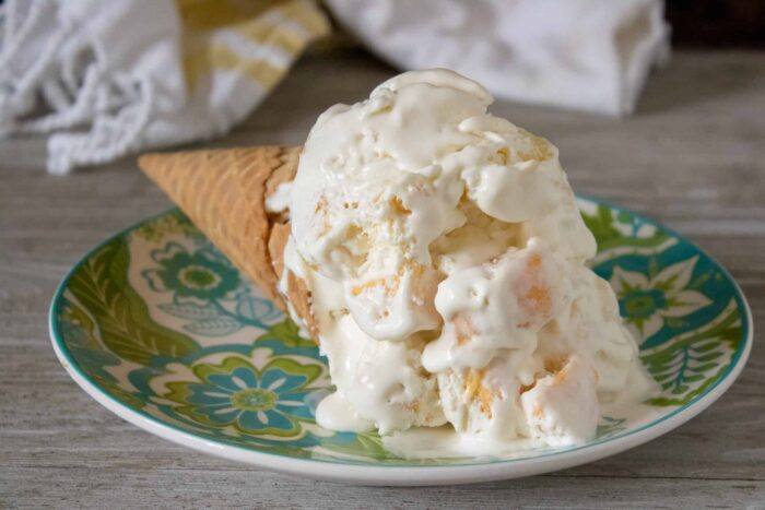 Tropical No-Churn Ice Cream served with a sugar cone on a blue and green patterned plate