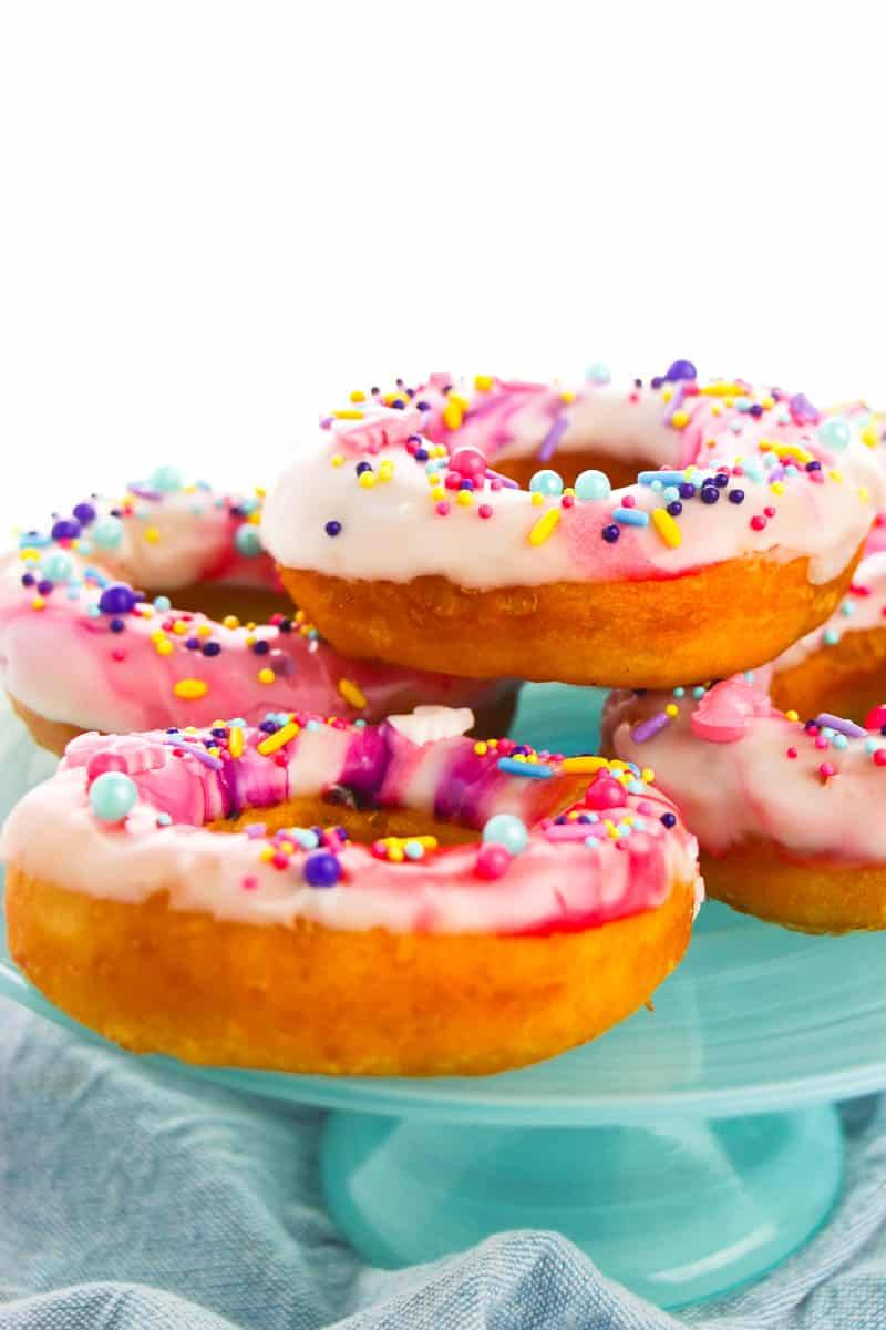side view of unicorn donuts on blue serving