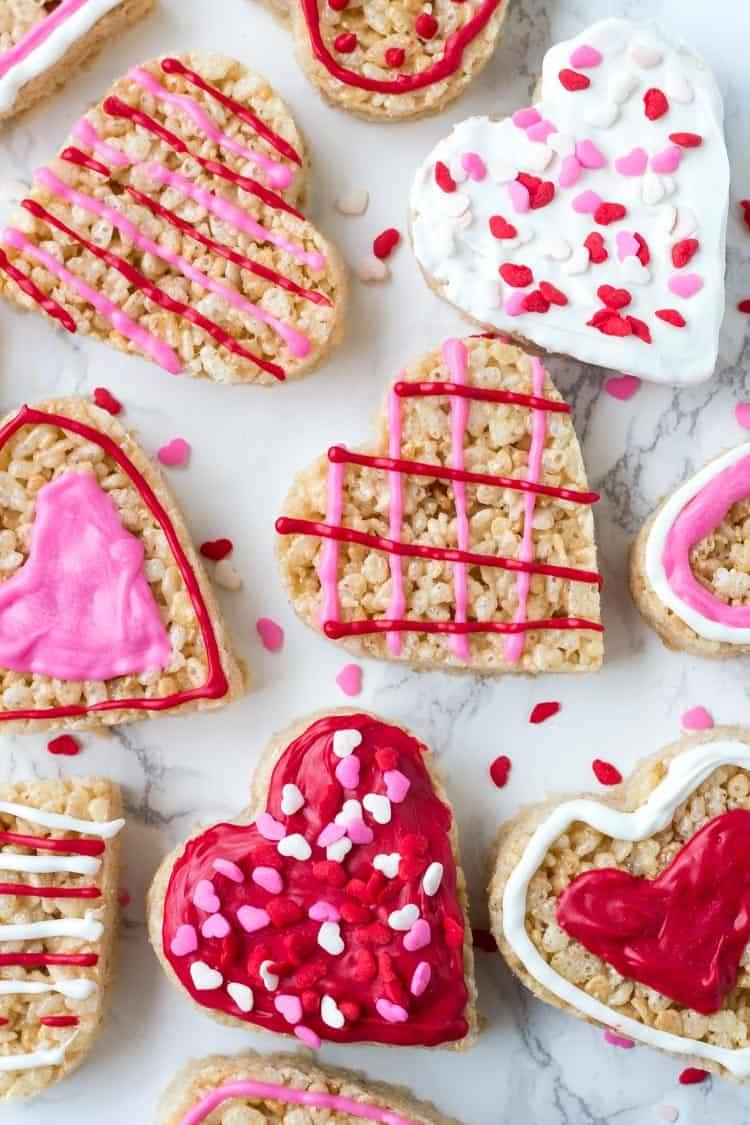 These Valentine's Rice Krispie treats are an easy, fun & festive recipe for February 14th. Kids will love making them, and they're a perfect treat to bring to school or Valentine's day parties.