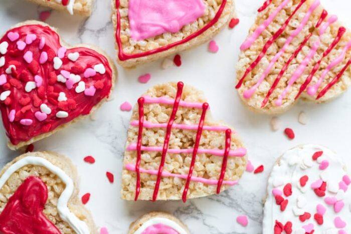 These Valentine's Rice Krispie treats are an easy, fun & festive recipe for February 14th. Kids will love making them, and they're a perfect treat to bring to school or Valentine's day parties.