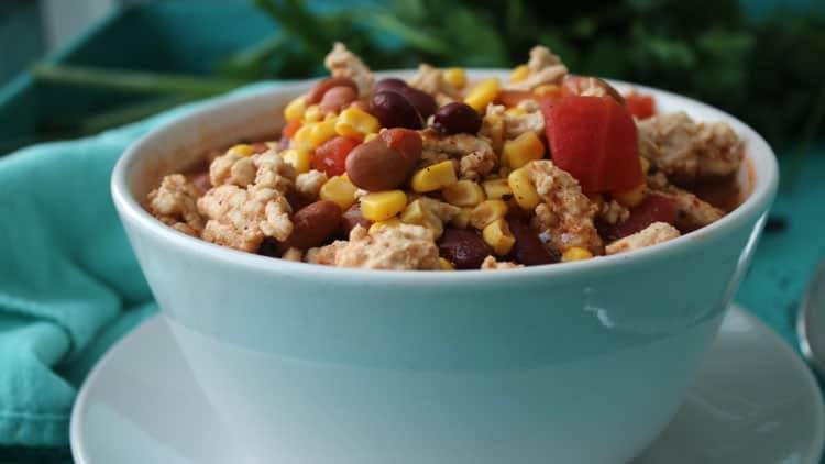 Close-up of a bowl of taco soup with turkey, kidney beans, corn and diced tomatoes
