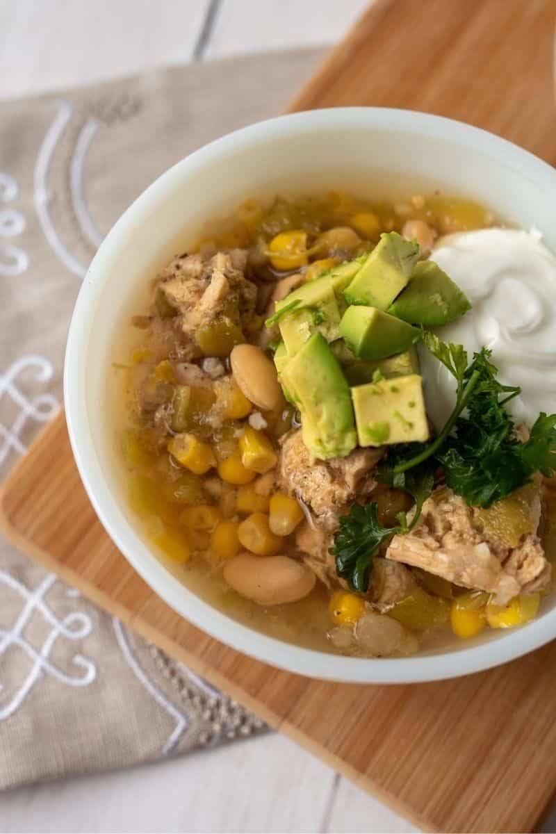 slow cooker white chicken chili being served in a white bowl, Image: Dreamstime