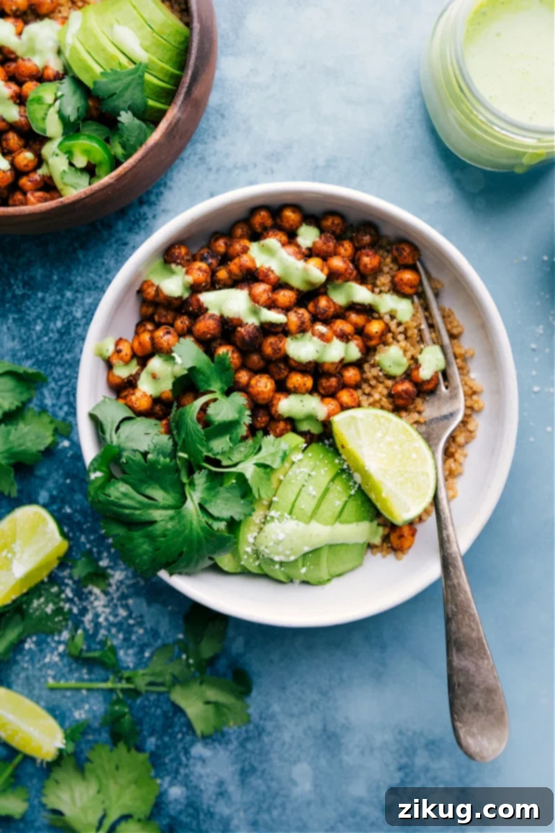 Vibrantly spiced Mexican Chickpeas served in a bowl, drizzled with creamy cilantro-lime sauce and garnished with fresh cilantro.