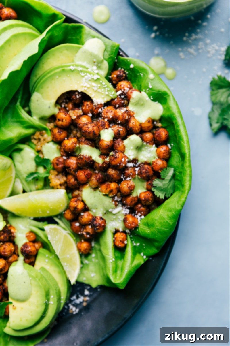 Delicious Mexican Chickpeas generously piled into crisp lettuce wraps, garnished with fresh herbs and lime wedges.