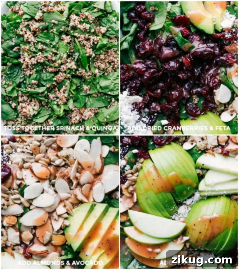 A vibrant arrangement of cooked quinoa, dried cranberries, crumbled feta cheese, sliced almonds, avocado, and chopped apples on a bed of fresh spinach.