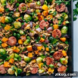 Butternut Squash Wild Rice Pilaf served in a bowl, showing the roasted vegetables, sausage, and rice