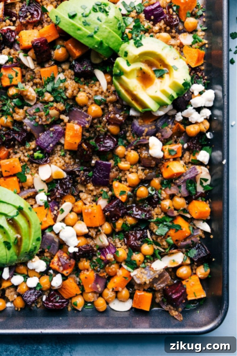 Overhead view of the sheet pan Quinoa Pilaf on a sheet pan, showcasing roasted vegetables, quinoa, and fresh herbs.
