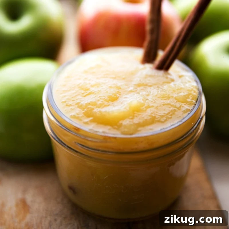 Fresh Applesauce for Making Applesauce Cake Fresh, unsweetened applesauce in a glass container, ready to be incorporated into the applesauce cake recipe.