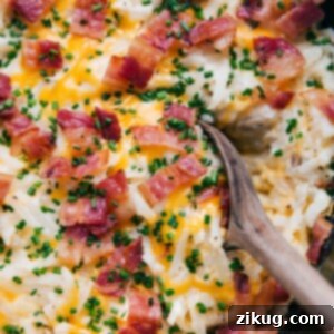 Irresistible Crockpot Hash Brown Bake 3 A warm, hearty scoop of crockpot hashbrown casserole, steaming and ready to be served.