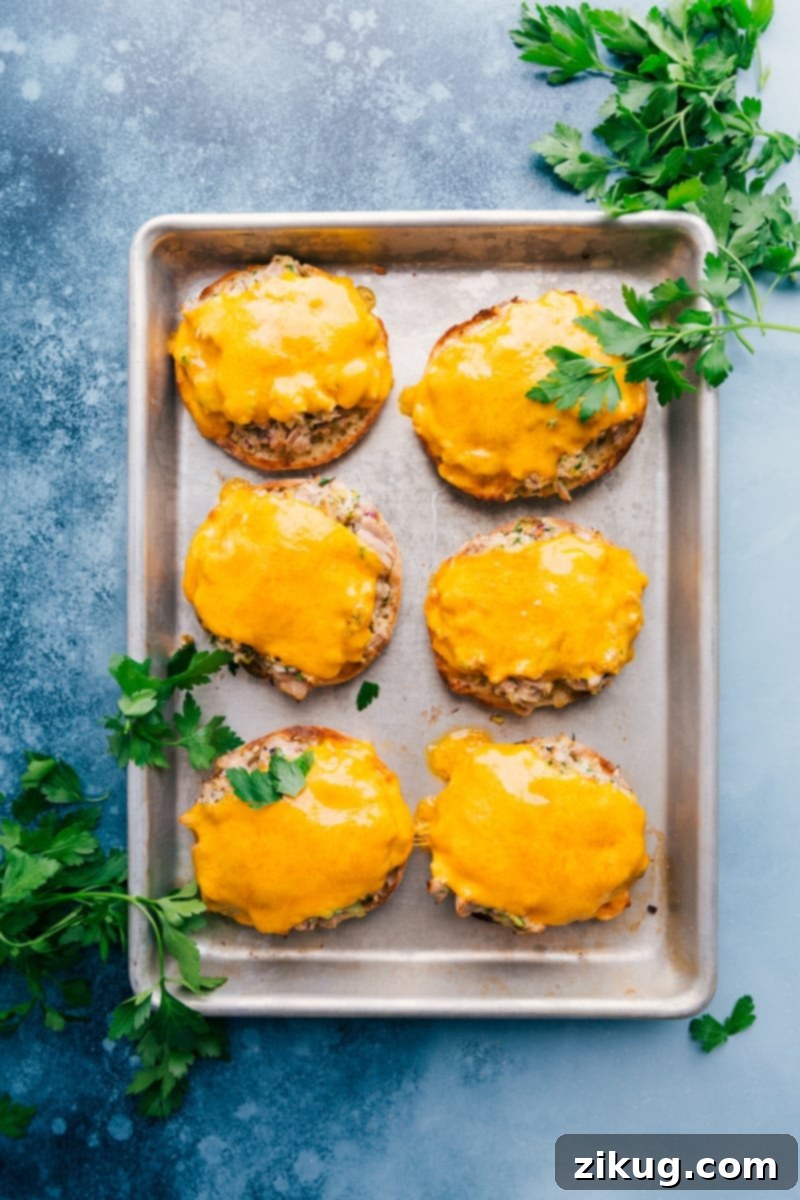 Make Tuna Melts with toasted English muffins, a simple creamy tuna mixture, and lots of melty Cheddar! Recipe via ChelseasMessyApron #dinner #quick #easy #simple #best #cheddar #bread #cheese #tuna #melts Delicious Tuna Melts on toasted English muffins with melted cheddar cheese