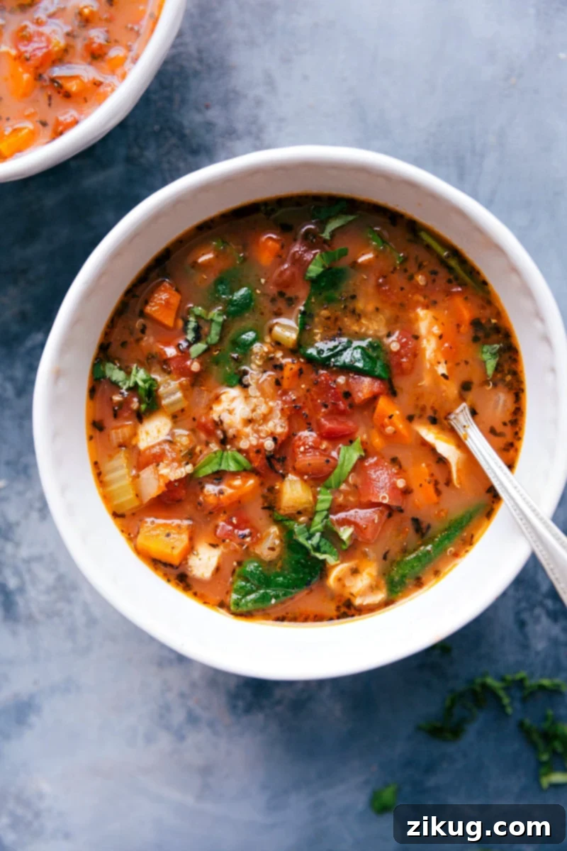 Cozy Bowl of Savory Crockpot Chicken Quinoa Soup A steaming bowl of hearty crockpot chicken quinoa soup, showcasing tender chicken, fluffy quinoa, vibrant vegetables, and fresh herbs, ready to be enjoyed.