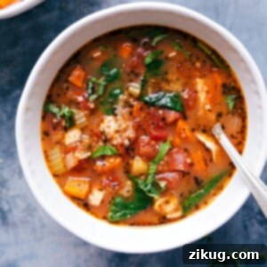 Wholesome Chicken Quinoa Bowl 3 A bowl of hearty crockpot chicken quinoa soup, with chicken, quinoa, vegetables, and herbs.