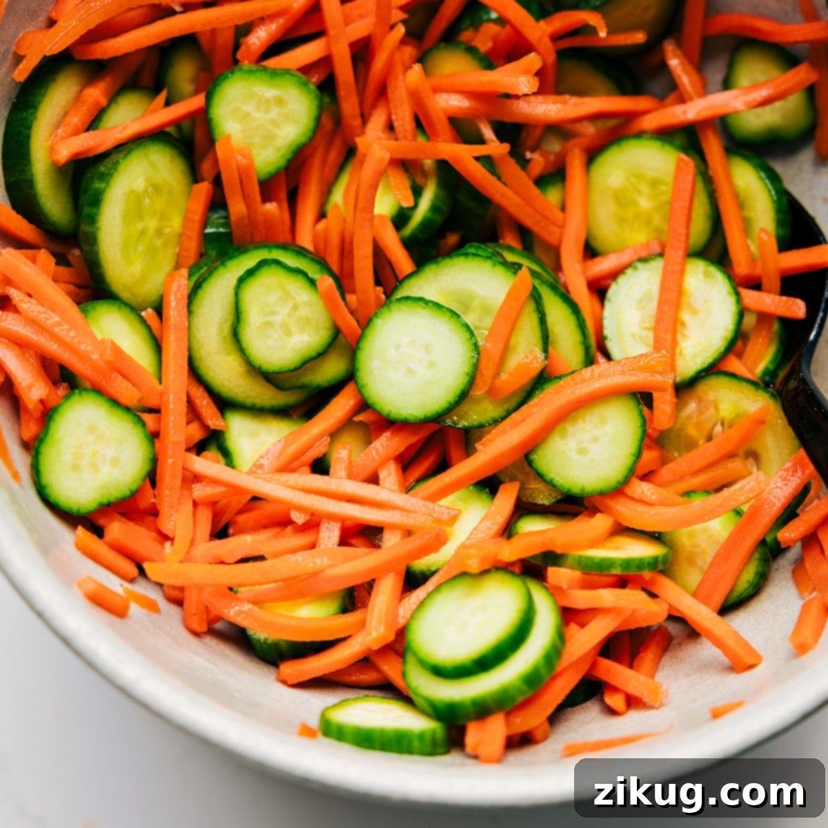 Serve Korean Ground Beef With A Cucumber Carrot Salad Quick cucumber and carrot salad mixed together in a bowl, ready to be served as a refreshing accompaniment to Korean Ground Beef.