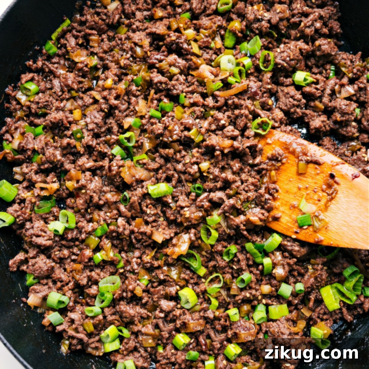 How To Make Korean Ground Beef The savory Korean Ground Beef mixture simmering in a skillet, topped with fresh green onions and ready to be served.
