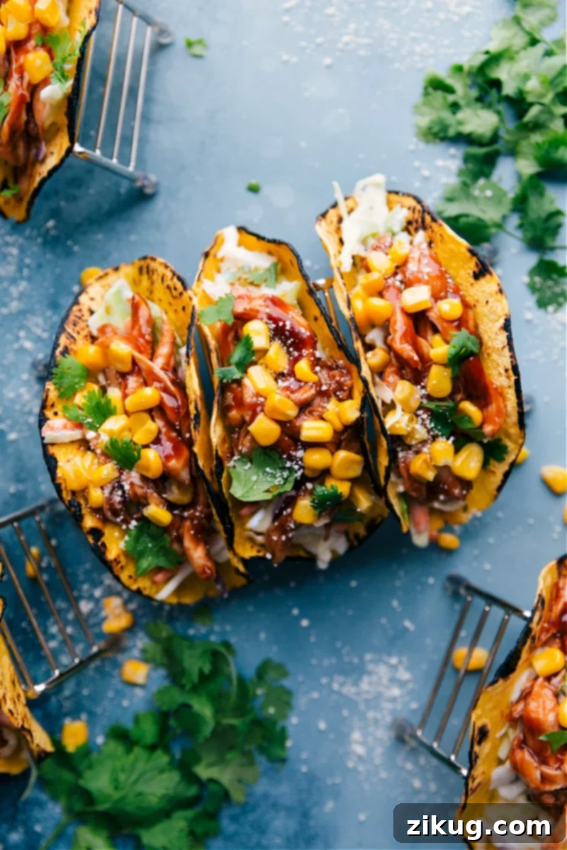 Smoky BBQ Chicken Tacos with Zesty Slaw 2 Delicious BBQ Chicken Tacos with creamy coleslaw, ready to eat.