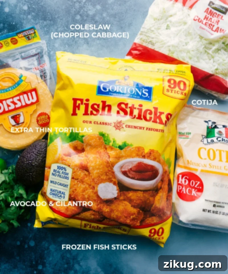 Ingredient shot, showcasing all the fresh and pantry ingredients needed to assemble the fish stick tacos, including fish sticks, cabbage, sour cream, mayo, lime, and various spices.