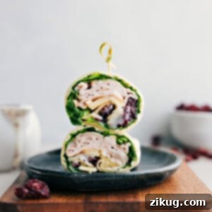 Turkey Cranberry Wrap on a plate stacked on top of each other.