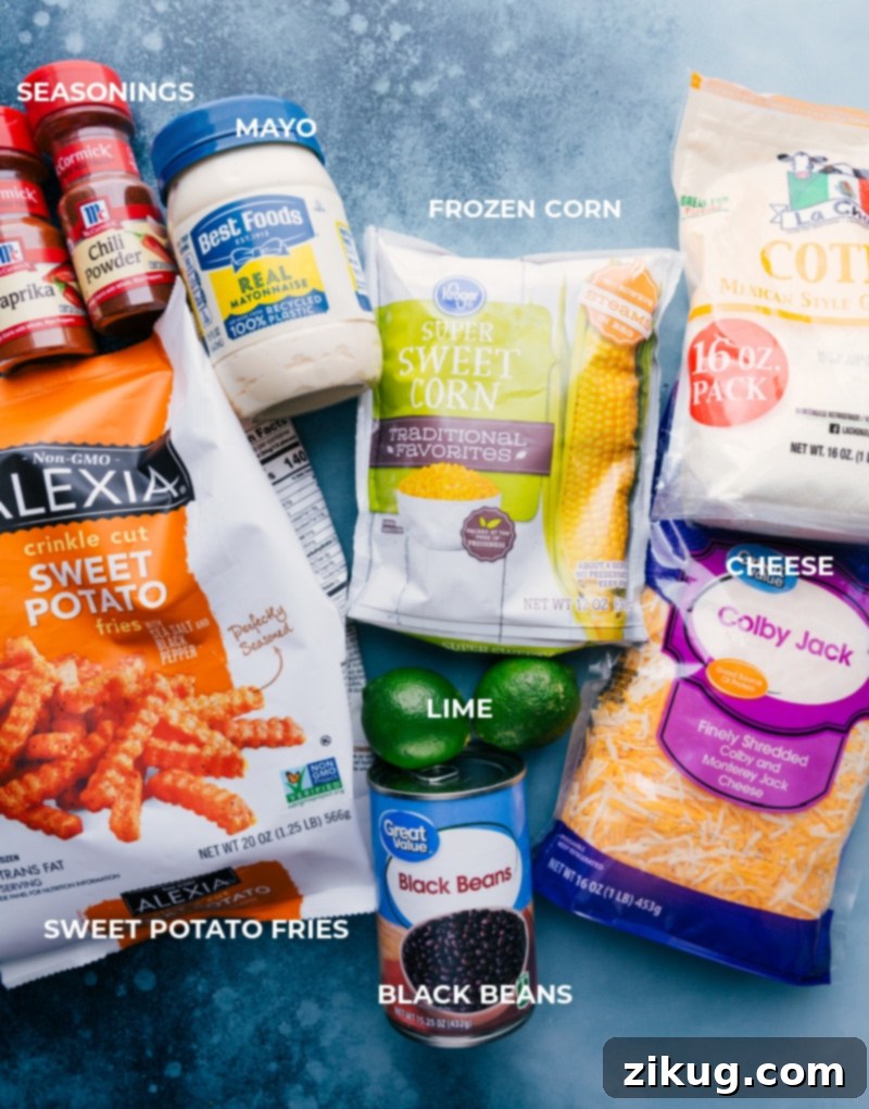 The essential ingredients for crafting perfect Sweet Potato Nachos: seasoned sweet potato fries, crisp corn, savory black beans, and a generous amount of cheese, all set to be baked and adorned with a homemade chili-lime sauce, avocado, and other favorite toppings for a delightful meal. A flat lay image displaying all the fresh ingredients for Sweet Potato Nachos, including sweet potato fries, black beans, corn, cheese, avocado, and lime, ready for preparation.