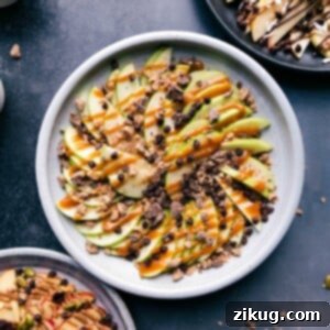 A vibrant platter of Apple Nachos, showcasing perfectly sliced apples drizzled with caramel and adorned with crunchy toppings.