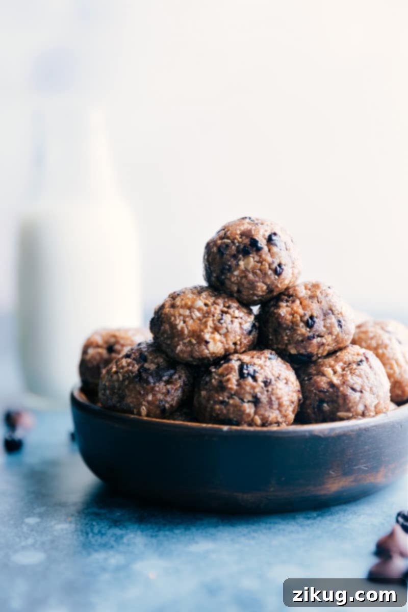 Blueberry Energy Bites: Healthy, Easy, and Delicious Snacks with Oats, Almond Butter, Coconut, Chocolate, and Dried Blueberries A vibrant close-up of Blueberry Energy Bites arranged artfully in a bowl, showcasing their texture and ingredients.