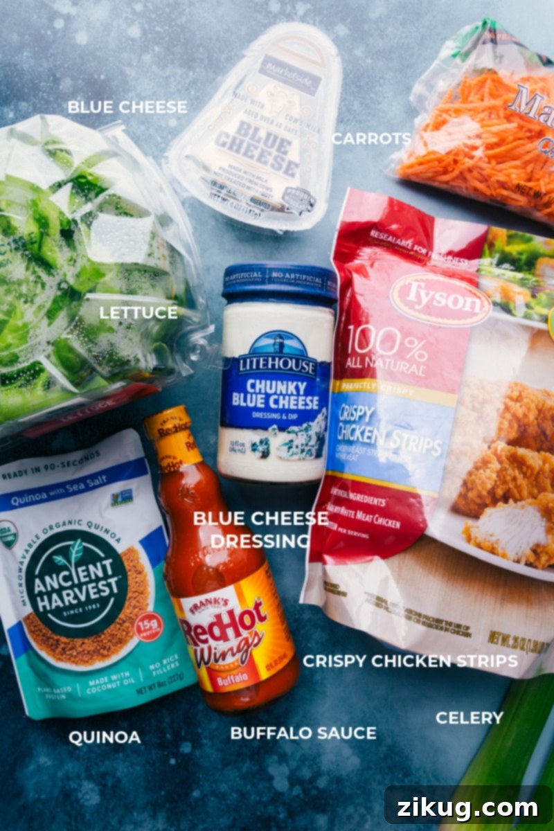 Ingredient shot showing all components for Buffalo Chicken Lettuce Wraps: crispy chicken strips, buffalo sauce, lettuce, quinoa, carrots, celery, cabbage, and dressing.