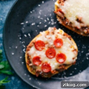 Overhead shot of a beautifully baked Texas Toast Pizza with perfectly melted cheese, savory ground beef, and mini pepperoni, garnished with fresh herbs.