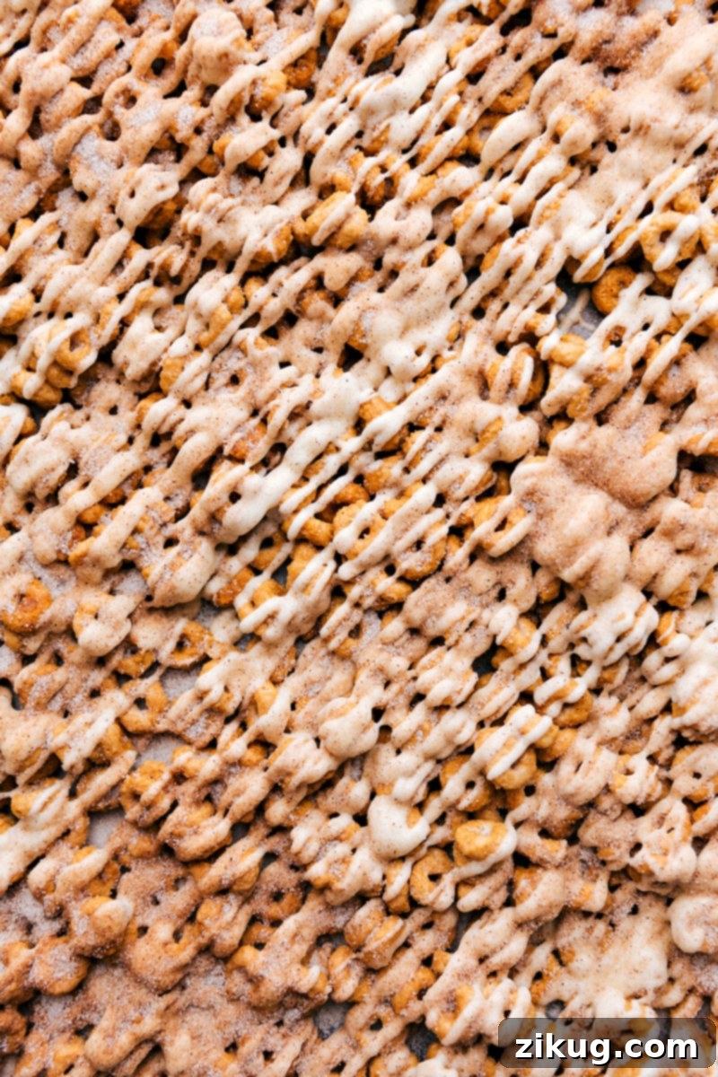 Churro Cheerios scattered on a plate, highlighting their delicious caramel, white chocolate, and cinnamon-sugar coating.