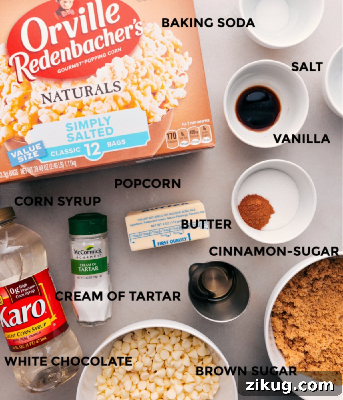 All the ingredients for this recipe are prepped and ready for easy assembly: popcorn, baking soda, salt, spices, cream of tartar, corn syrup, sugar, and chocolate.