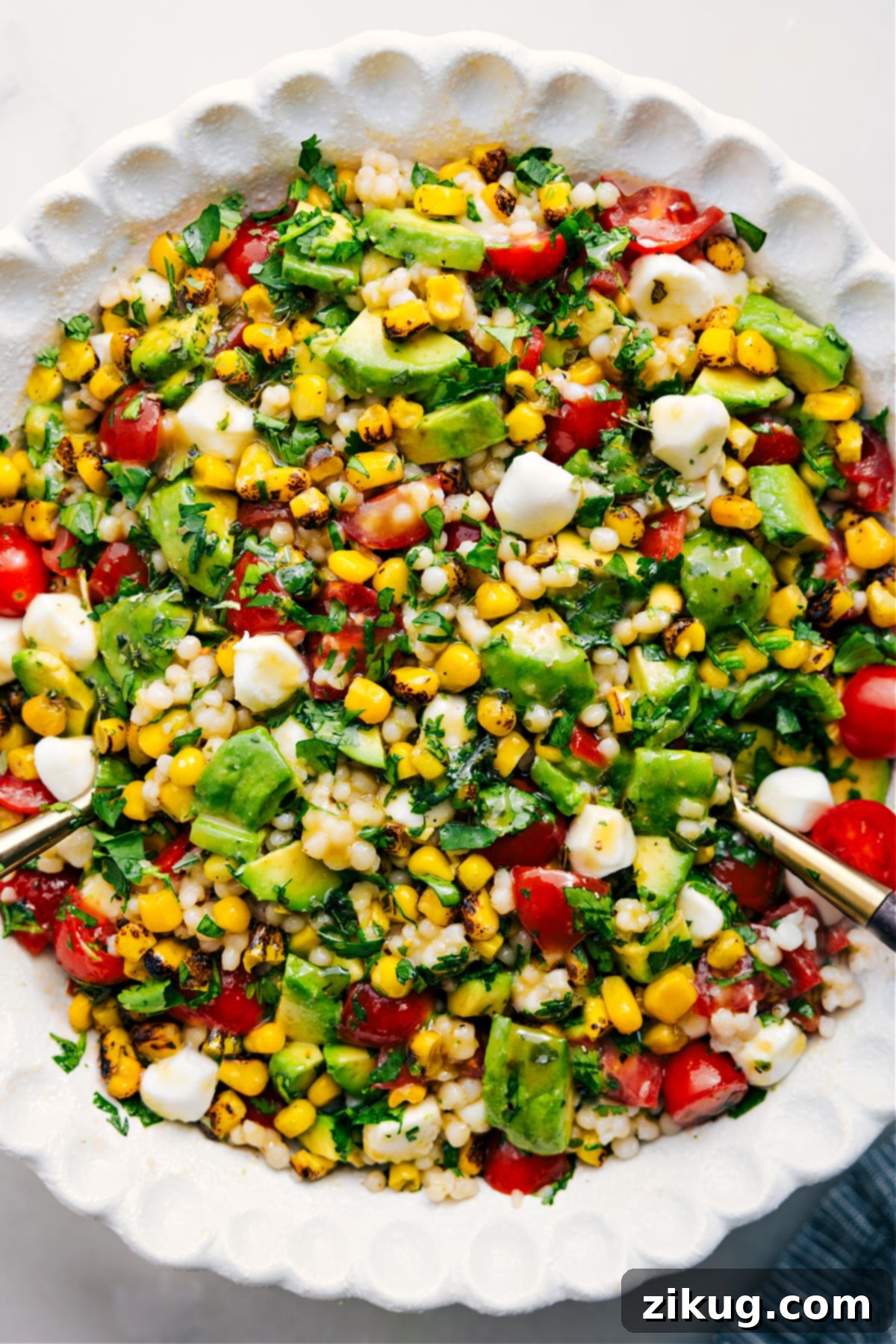 A large, inviting bowl of flavorful Summer Couscous Salad, expertly dressed and ready to be enjoyed as the perfect summer meal.