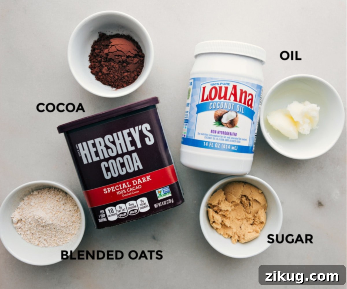 Prepping for Homemade Oreo Crumbs in Energy Bites The separate ingredients for the optional homemade Oreo crumble, including oat flour, cocoa powder, sugar, and coconut oil, are neatly prepped for easy addition to the Cookies and Cream Energy Bites.