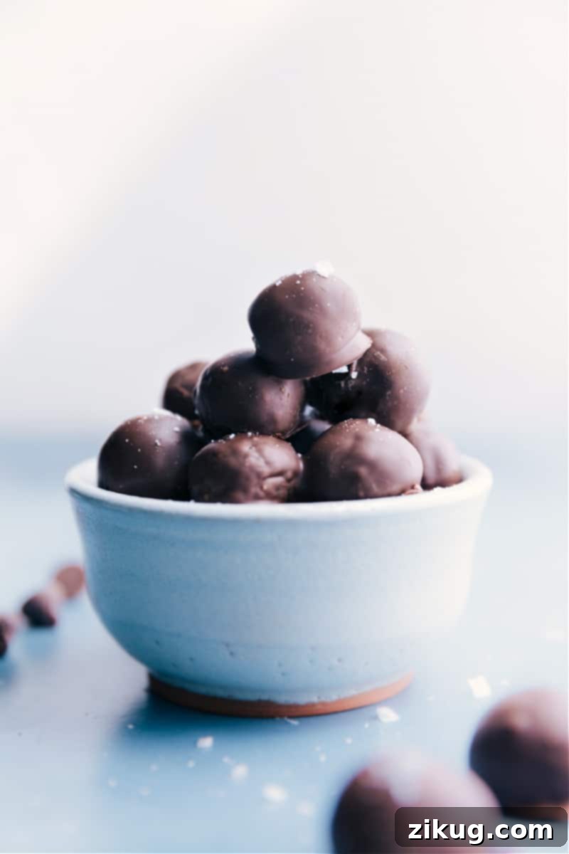 Healthy Chocolate-Covered Caramels: A delicious, refined sugar-free treat made with dates and dark chocolate. Perfect for a quick, easy, and kid-friendly healthy dessert. A beautiful bowl filled with Healthy Chocolate-Covered Caramels, showcasing their rich dark chocolate coating and soft, inviting texture.