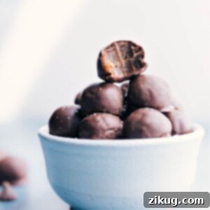 Decadent Healthy Chocolate Chews 2 A close-up image of a single Healthy Chocolate-Covered Caramel, perfectly coated in dark chocolate, inviting a delicious bite.