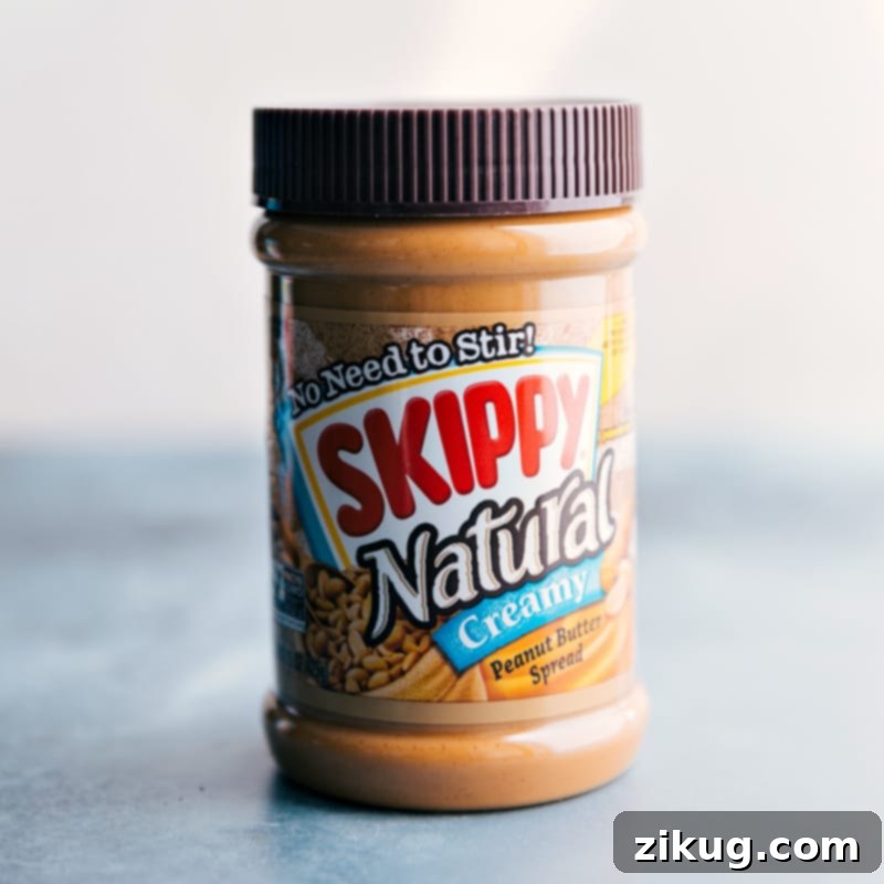 A jar of creamy peanut butter, a key ingredient for these delicious cereal bites.