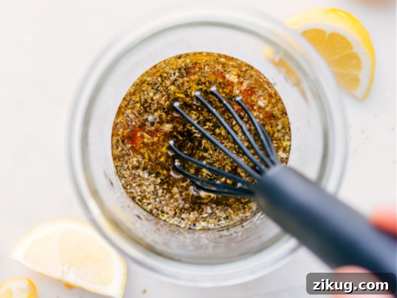 Image of Greek Salad Dressing being whisked together in a bowl