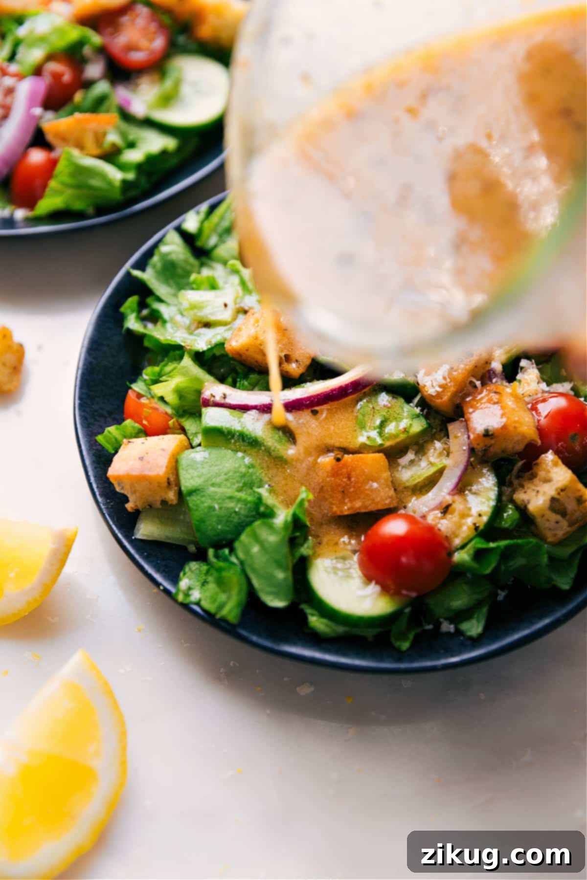 The Best Lemon Dressing Fresh Lemon Vinaigrette poured generously over a vibrant green salad, making it irresistible.
