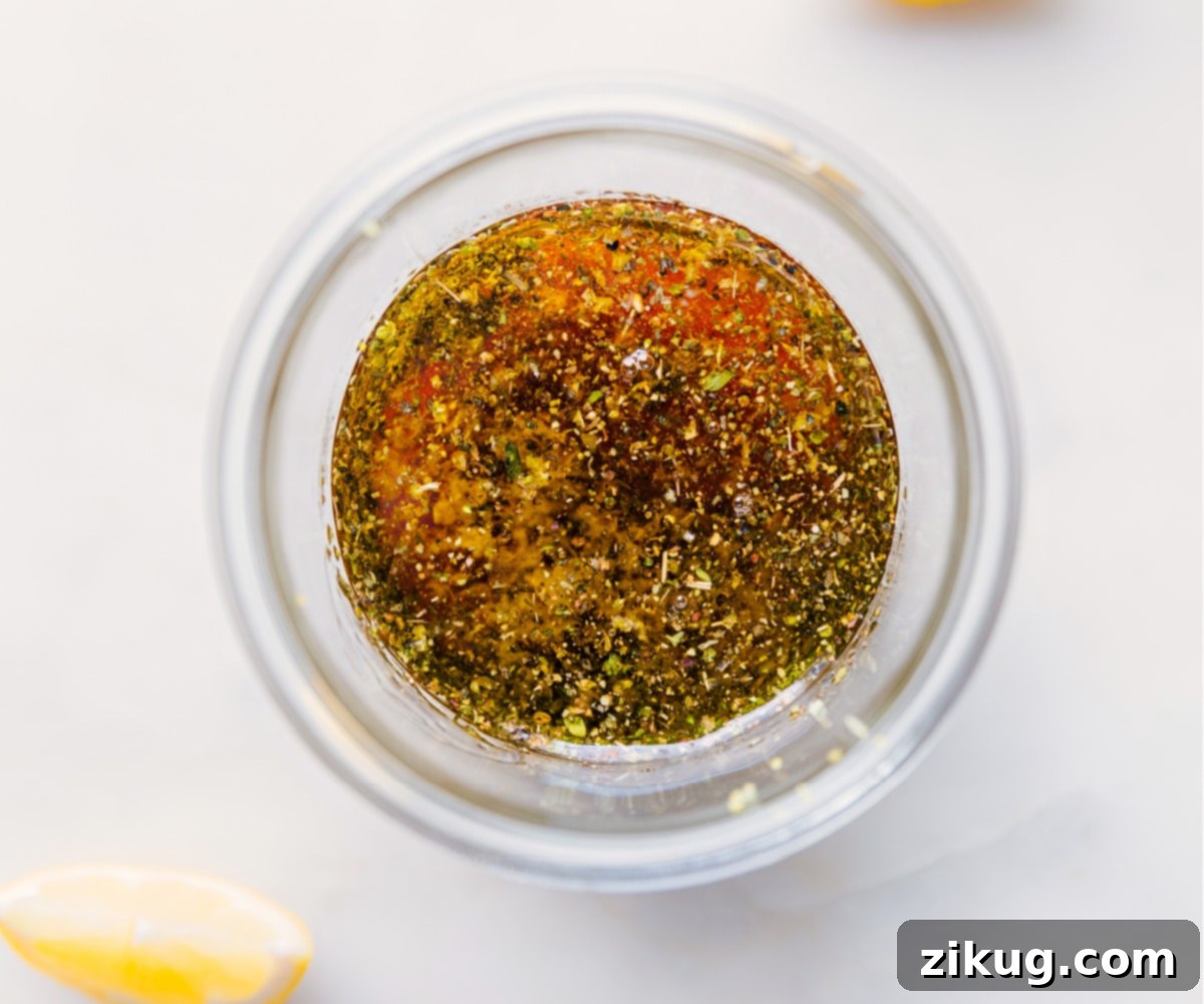 This zippy and tangy Lemon Vinaigrette is hands down my favorite dressing recipe! A must-have recipe in your cooking arsenal! Recipe via ChelseasMessyApron #dressing #best #quick #easy #lemonjuice #seasonings #salad #saladdressing #lemon #vinaigrette All the lemon vinaigrette ingredients, including fresh lemon, olive oil, and Dijon mustard, ready to be combined in a mason jar.