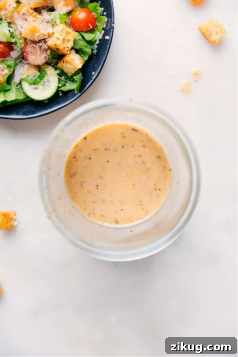 Herbed Italian Vinaigrette 2 Freshly made Italian dressing in a stylish glass jar, showcasing its vibrant color and fresh herbs, ready to be poured over a meal.