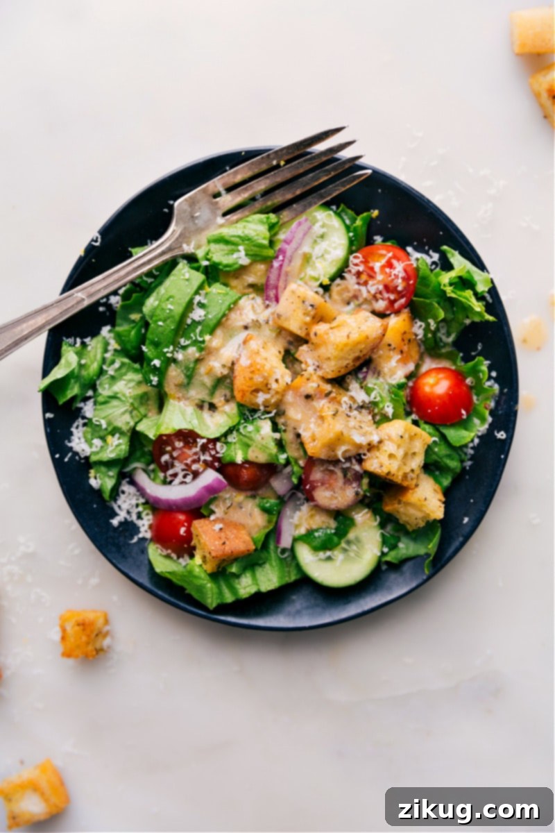 Herbed Italian Vinaigrette 8 An overhead view of a fresh, healthy salad generously topped with homemade Italian dressing, glistening and ready to be enjoyed.