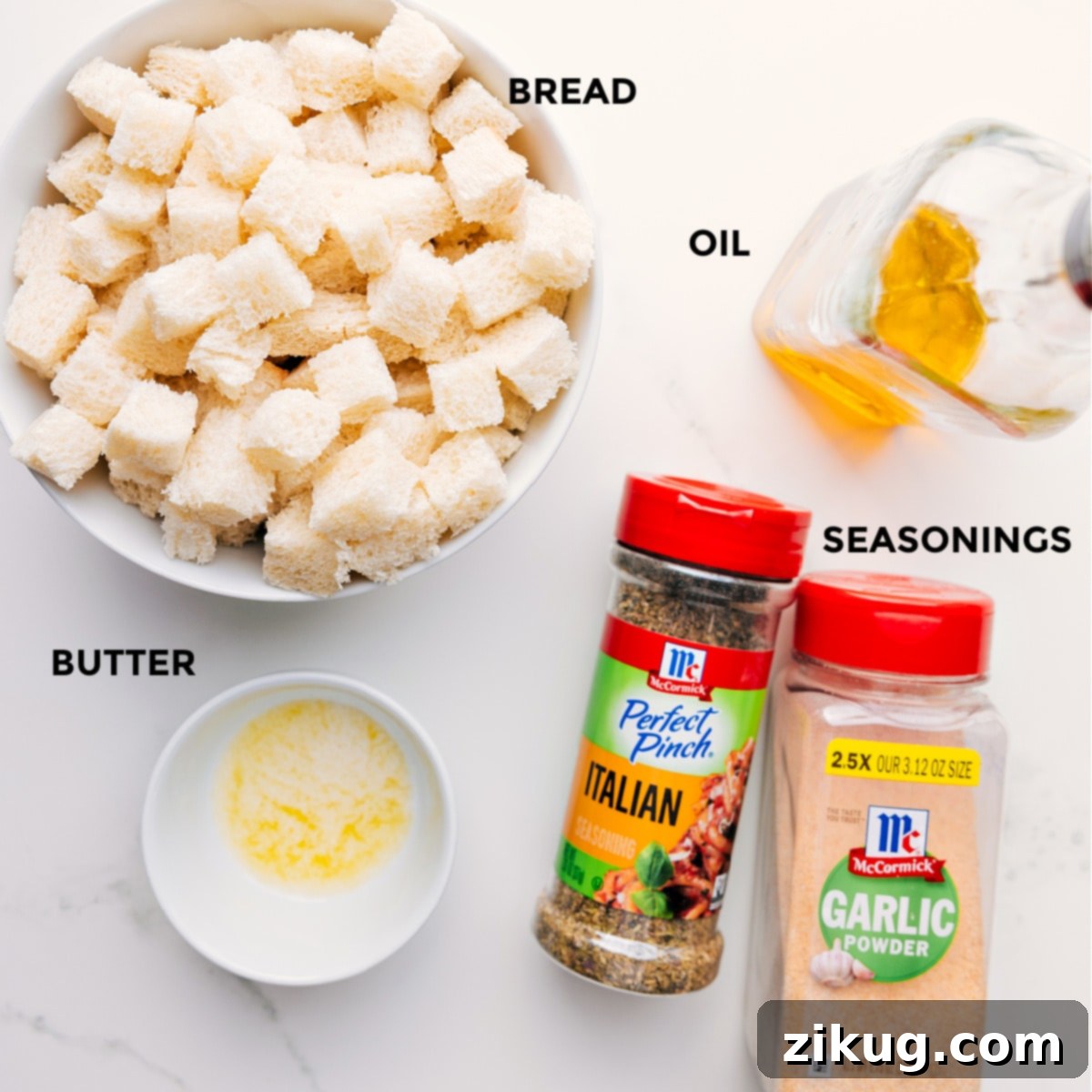 All ingredients prepped and laid out for easy assembly: cubed bread, olive oil, melted butter, Italian seasoning, garlic powder, salt, and pepper.