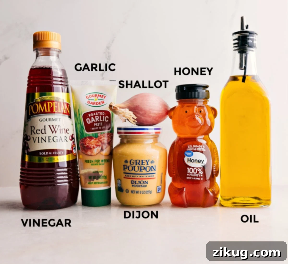 Ingredients for a quick and simple garden salad dressing: honey, extra virgin olive oil, finely minced shallot, Dijon mustard, minced garlic, and red wine vinegar.