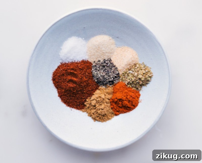 This Homemade Taco Seasoning blend showcases individual spices before mixing, highlighting the fresh, simple ingredients you'll use. Individual taco seasoning spices displayed in a compartmentalized bowl