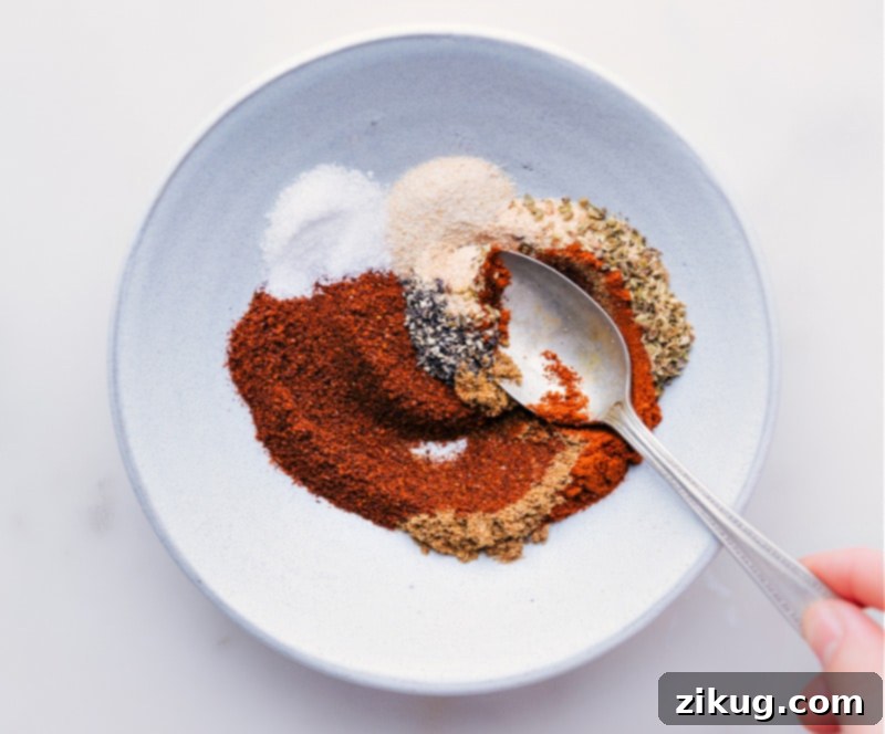 Watch how easily these everyday spices come together to create the best homemade Taco Seasoning blend! Taco seasoning spices being mixed together in a bowl