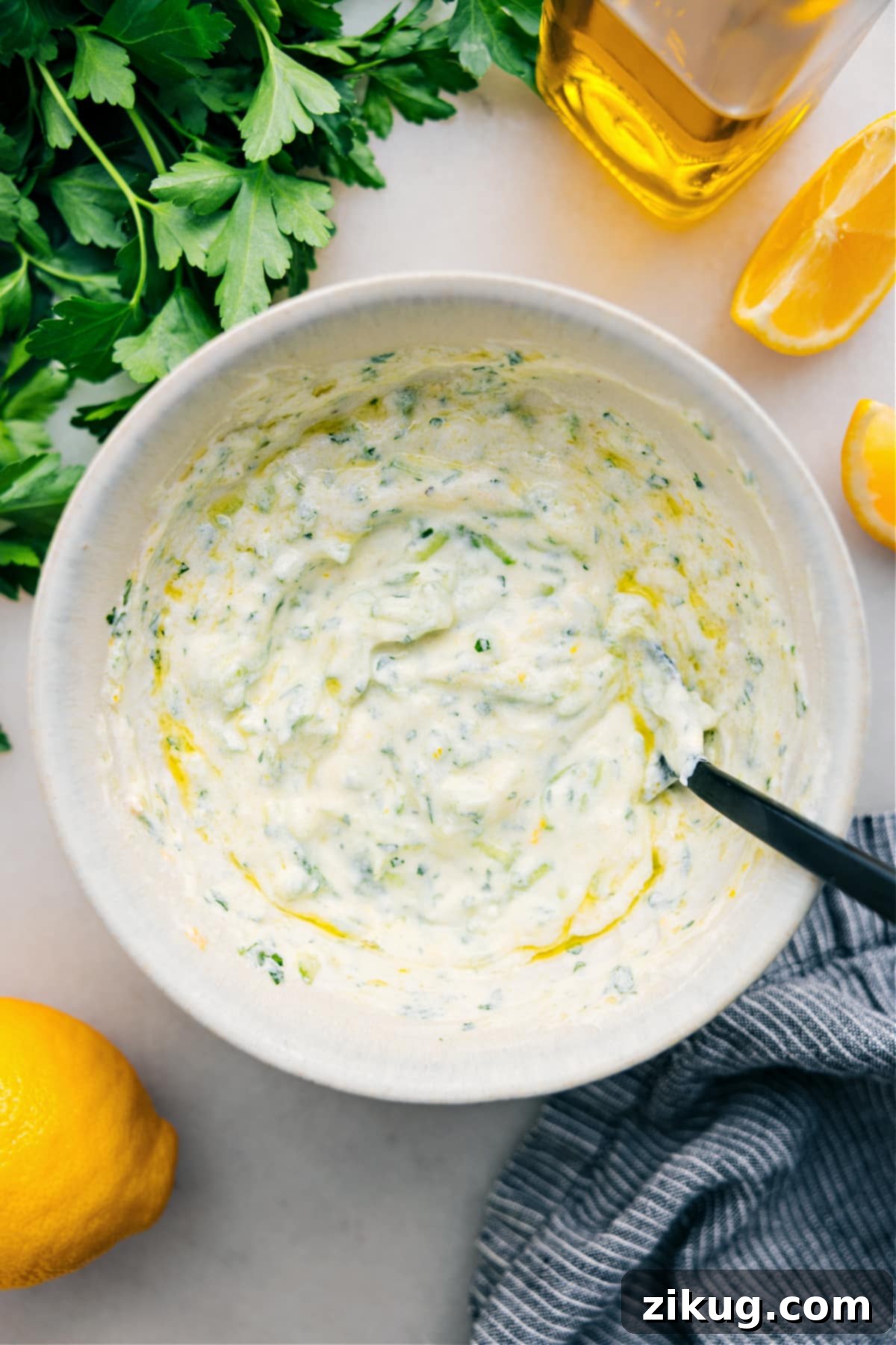 The Best And Easiest Homemade Tzatziki Sauce Recipe A beautifully presented bowl of freshly made Tzatziki Sauce, garnished with fresh dill and a slice of cucumber, ready to be enjoyed as a dip or accompaniment.