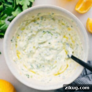A close-up of a perfectly prepared serving of fresh Tzatziki Sauce in a small, elegant bowl, garnished for presentation.