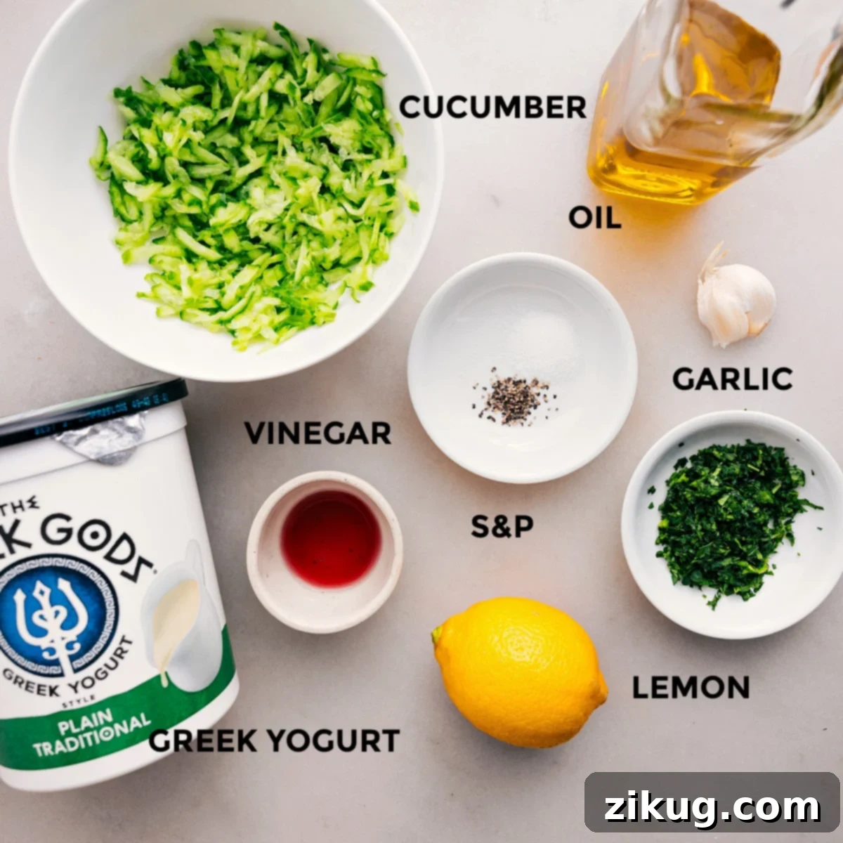 Essential Ingredients for Authentic Tzatziki Sauce All the fresh ingredients for Tzatziki Sauce are neatly arranged on a rustic wooden board: creamy Greek yogurt, vibrant English cucumbers, a bright lemon, whole fresh garlic cloves, golden olive oil, deep red wine vinegar, and a delightful medley of fresh herbs like mint and dill.