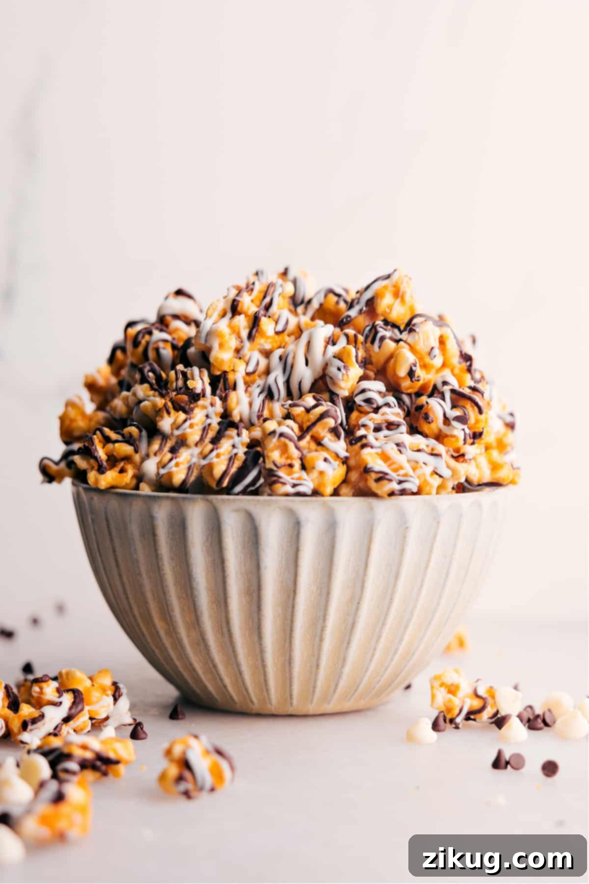 The Ultimate Homemade Zebra Popcorn Recipe A generous bowl of homemade Zebra Popcorn, featuring crispy caramel-coated kernels beautifully drizzled with contrasting white and dark chocolate stripes. Ready to be enjoyed as a festive snack or sweet treat.