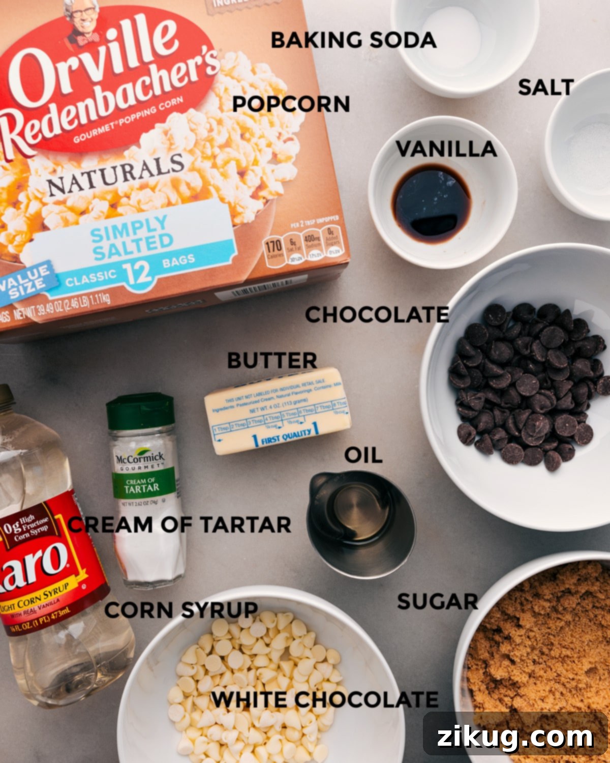 Key Ingredients for Delicious Zebra Popcorn All essential ingredients for Zebra Popcorn laid out for preparation: baking soda, salt, unpopped corn kernels, vanilla extract, dark chocolate, white chocolate, butter, cream of tartar, corn syrup, and light brown sugar.