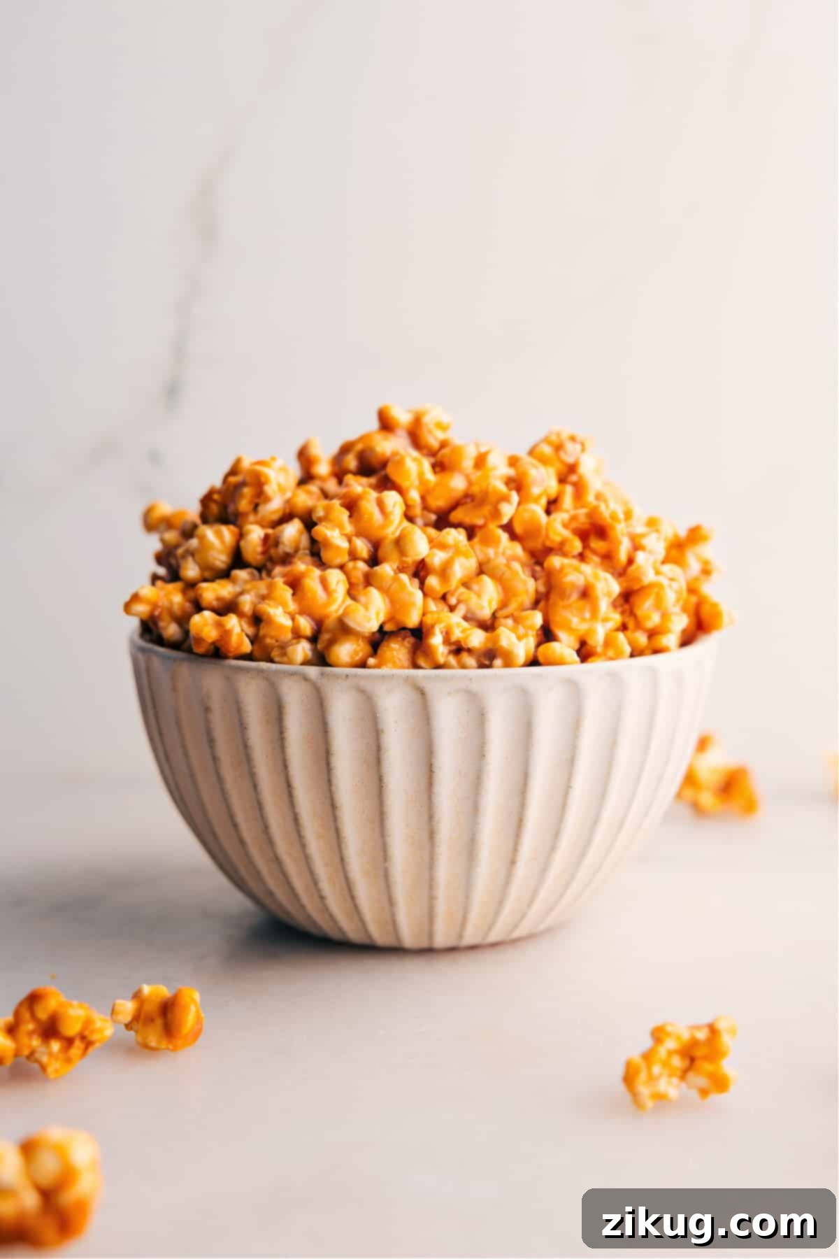 The Best Homemade Caramel Corn Recipe Delicious Caramel Corn Recipe in a large bowl, glistening with caramel and ready to be enjoyed.
