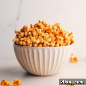 Close-up of freshly made, golden caramel corn in a bowl.